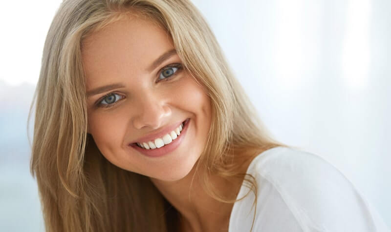 Person with a radiant smile after teeth whitening treatment