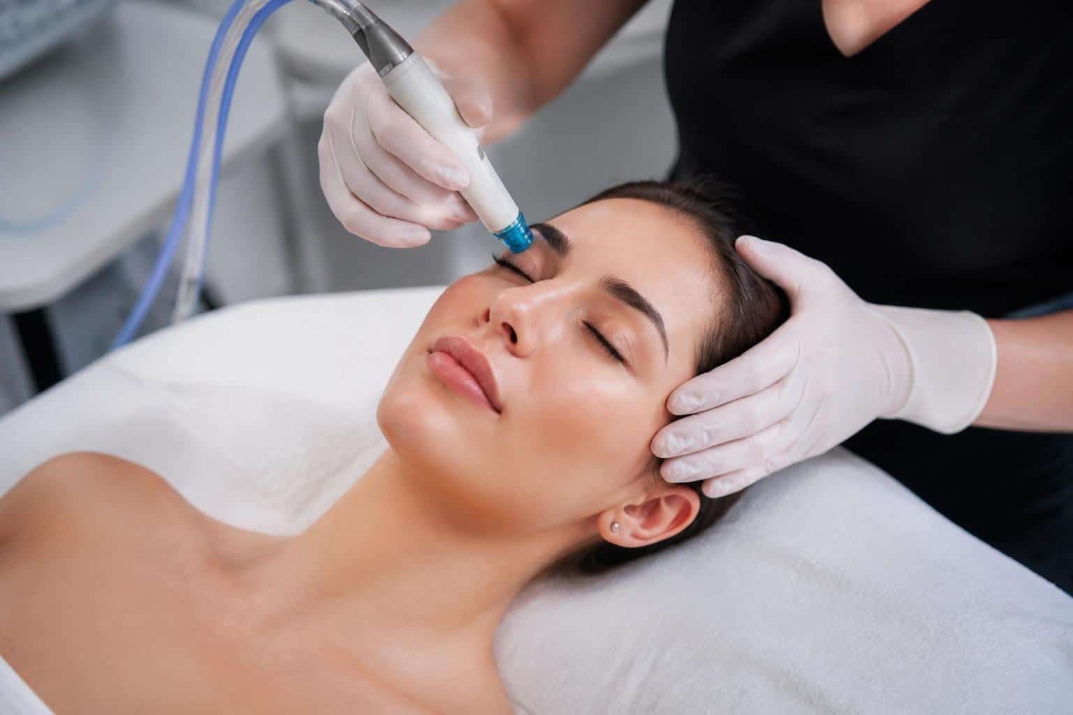 HydraFacial wand treating client's face